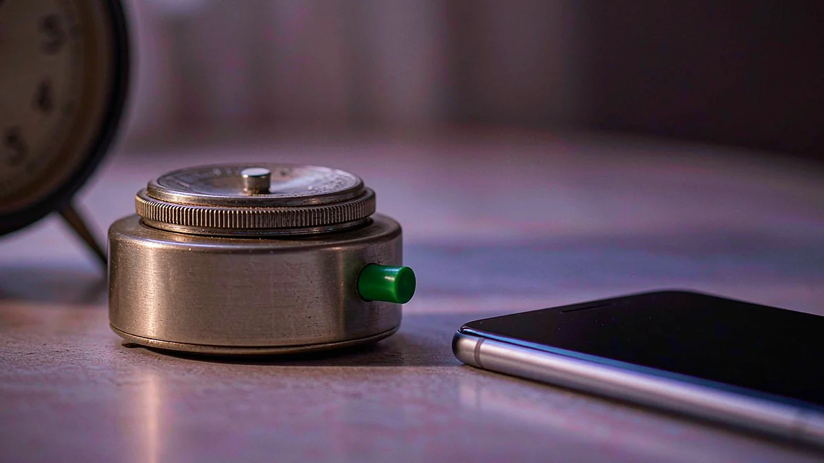 Small timer beside a smartphone